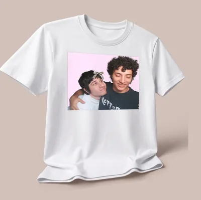 Playful illustration of two friends embracing on a colorful gaming-themed — printed on a unisex t-shirt (angled view)
