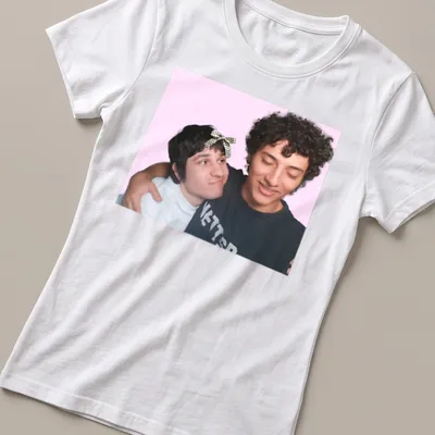 Playful illustration of two friends embracing on a colorful gaming-themed — printed on a women's shirt