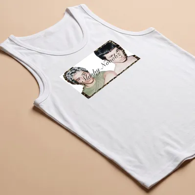 Photographic design depicting two young men with unique hairstyles and the text 'Slushy Nooobz'. — printed on a tank top