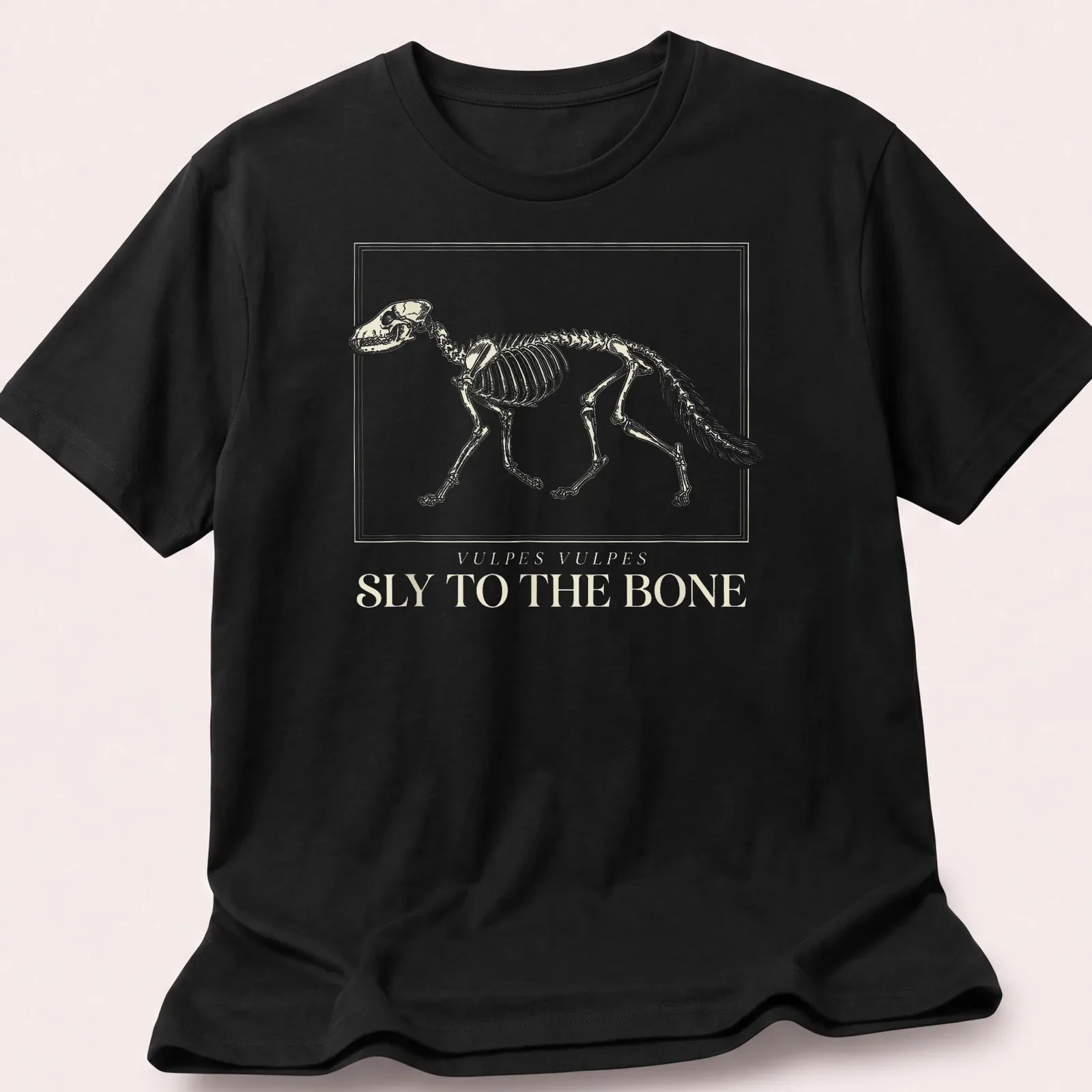 Scientific illustration of a fox skeleton with the text 'Vulpes Vulpes Sly To The Bone' — printed on a unisex t-shirt