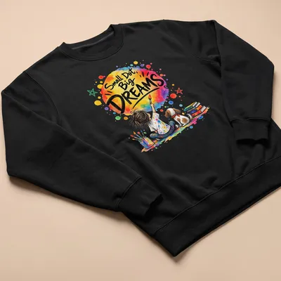 Colorful watercolor design of a young artist and dog with text Small Dot, Big DREAMS — printed on a unisex sweatshirt