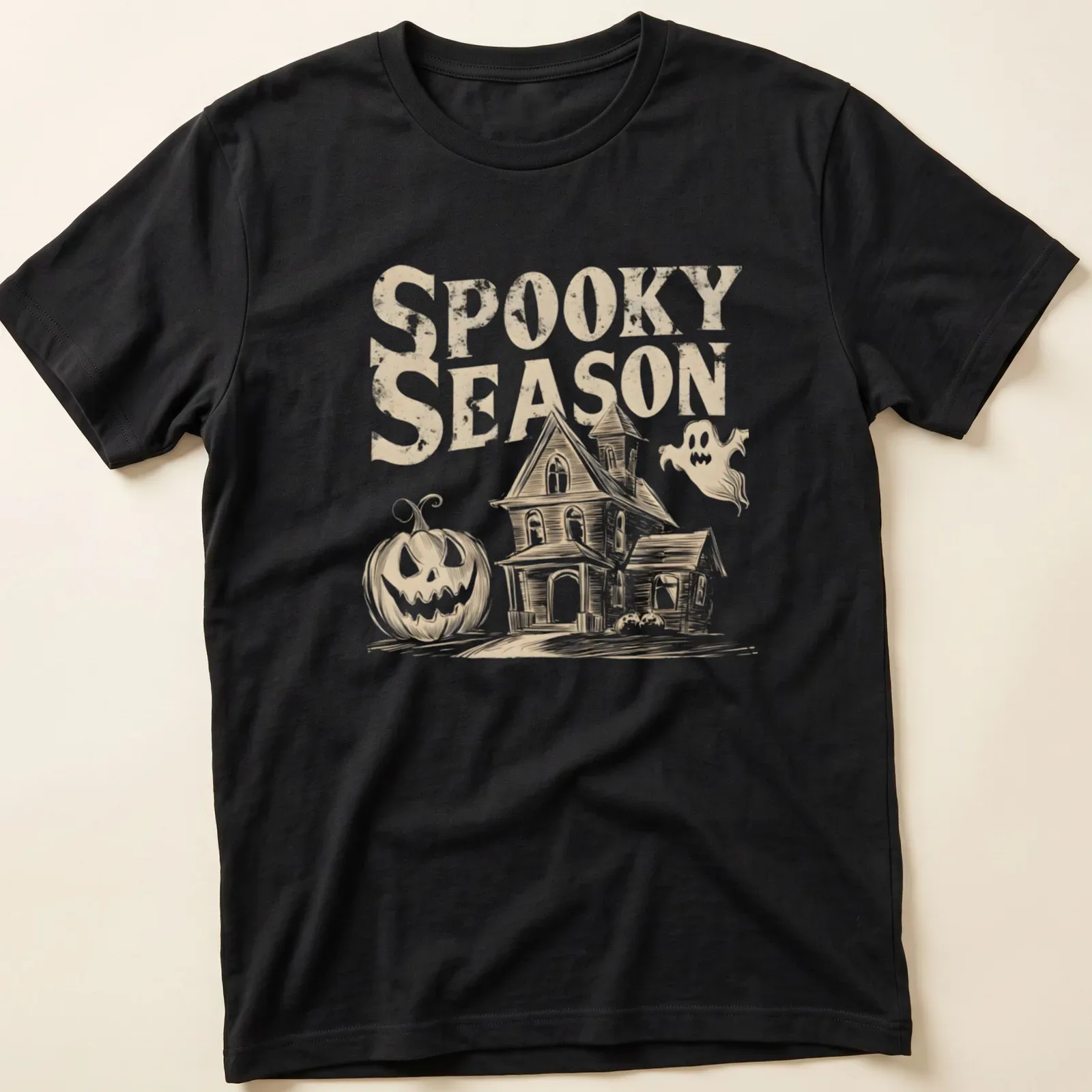 Vintage haunted house, pumpkin, and ghost graphic with text 'Spooky Season' in beige, white, and black. — printed on a unisex t-shirt