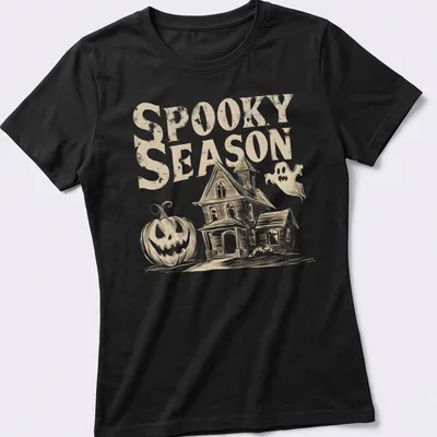 Vintage haunted house, pumpkin, and ghost graphic with text 'Spooky Season' in beige, white, and black. — printed on a women's shirt