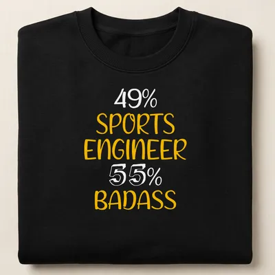 Bold yellow typography on a black shirt saying Sports Engineer Badass — printed on a unisex sweatshirt