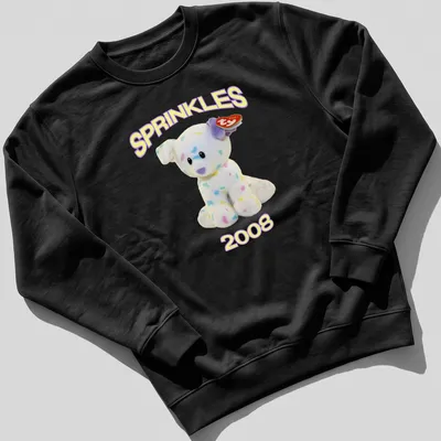 Cute cartoon plush dog with pastel colors and 'SPRINKLES 2008' text — printed on a unisex sweatshirt