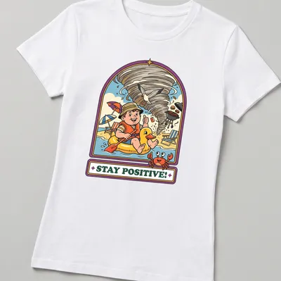 Vintage cartoon t-shirt showing a child in a duck float during a tornado with the text Stay Positive! — printed on a women's shirt