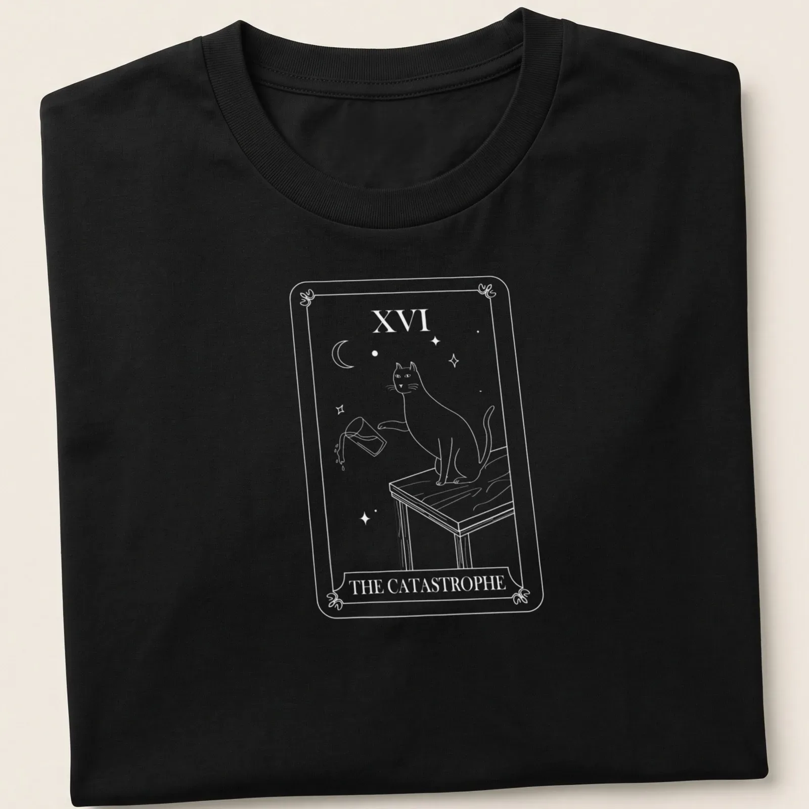 Tarot card style T-shirt featuring a humorous cat design with the text The Catastrophe — printed on a unisex t-shirt
