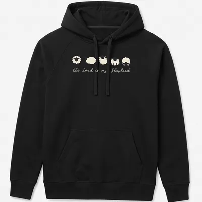 Minimalist sheep illustration with the text 'the Lord is my Shepherd' in cream and black. — printed on a unisex hoodie
