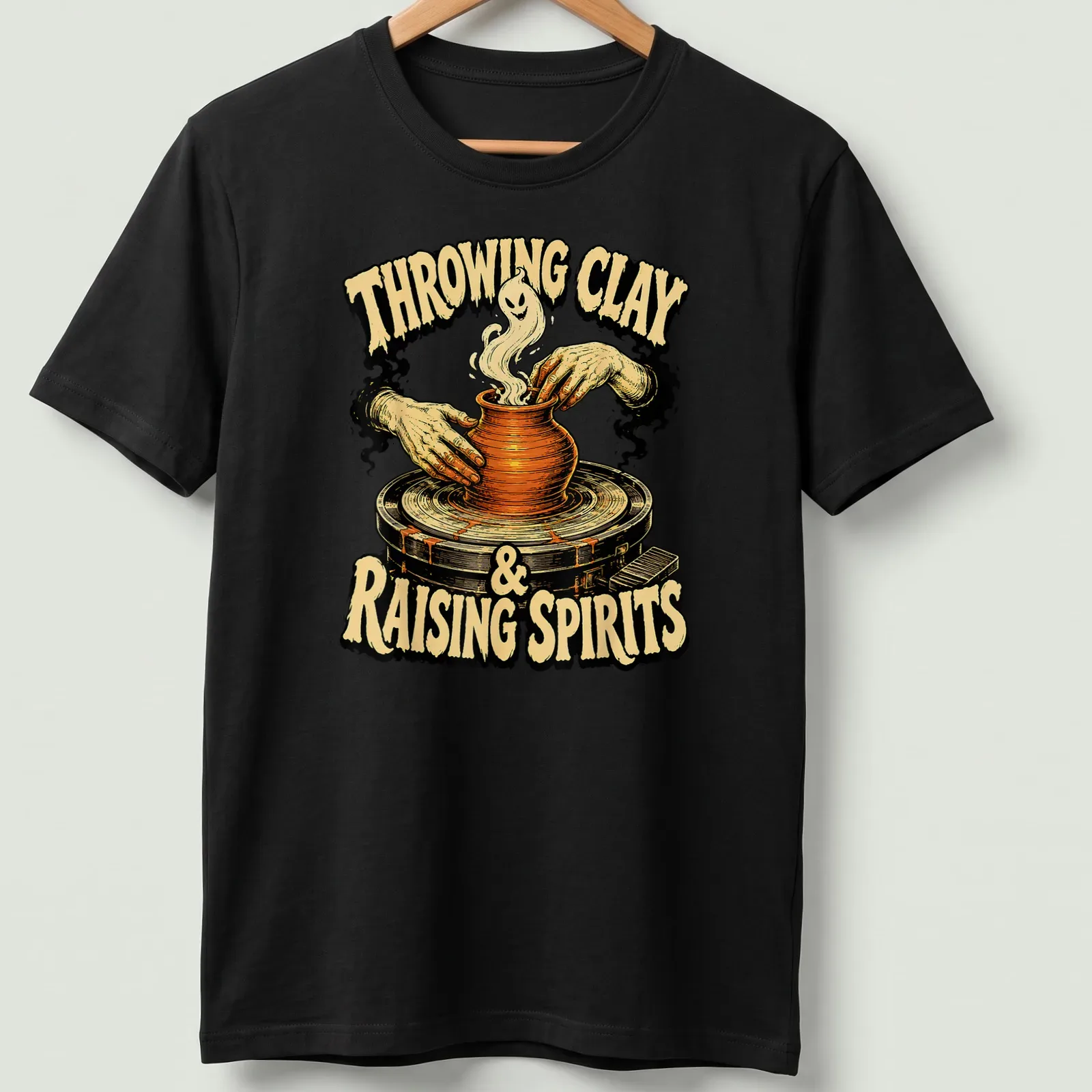 Vintage illustration of hands shaping pottery with a ghost, featuring Halloween-themed text — printed on a unisex t-shirt