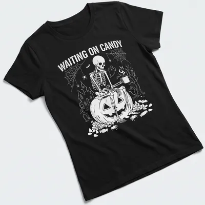 Spooky illustration of a skeleton on a pumpkin with text saying 'Waiting on Candy' — printed on a women's shirt