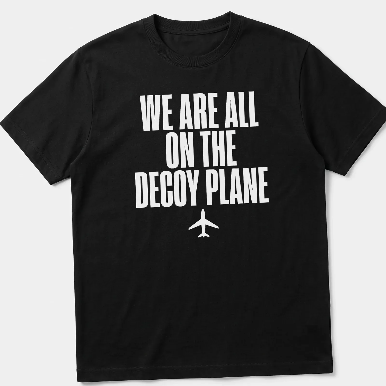 Bold typography t-shirt with the quote 'We Are All On The Decoy Plane' in white — printed on a unisex t-shirt