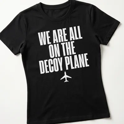 Bold typography t-shirt with the quote 'We Are All On The Decoy Plane' in white — printed on a women's shirt