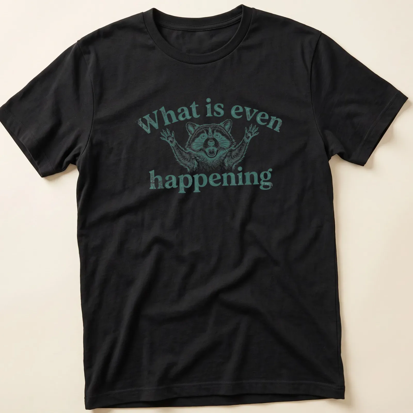 Vintage distressed t-shirt featuring a confused raccoon with humorous text above. — printed on a unisex t-shirt