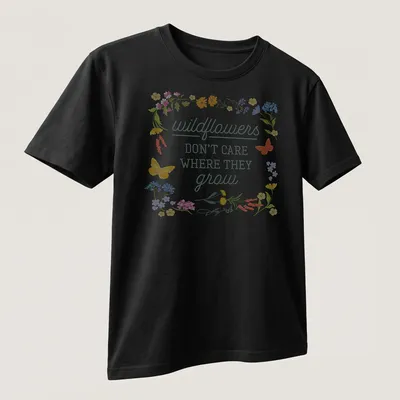 Floral illustration t-shirt with wildflowers and butterflies in various colors — printed on a unisex t-shirt (angled view)