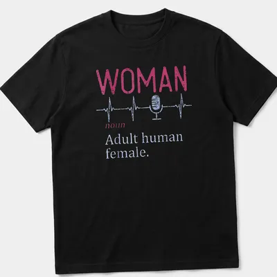 Distressed typography shirt featuring a microphone and heartbeat line with the text 'WOMAN noun Adult human female.'