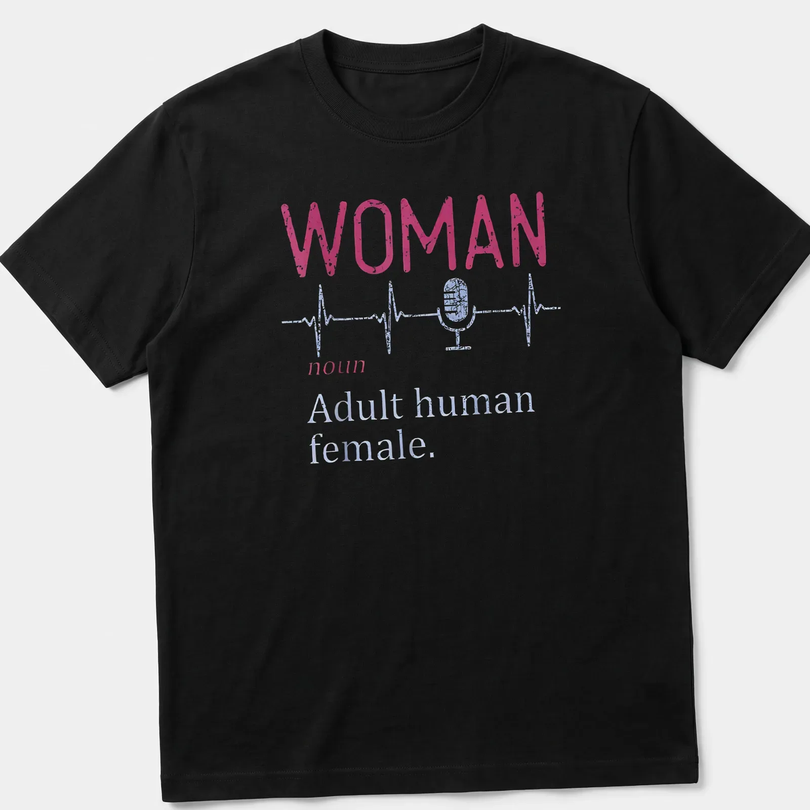 Distressed typography shirt featuring a microphone and heartbeat line with the text 'WOMAN noun Adult human female.' — printed on a unisex t-shirt