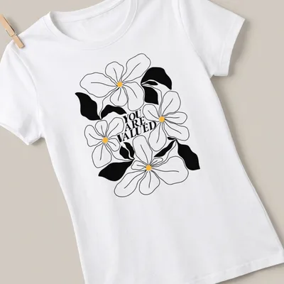 Line-art design featuring flowers with the phrase 'YOU ARE VALUED' in black, white, and yellow. — printed on a women's shirt