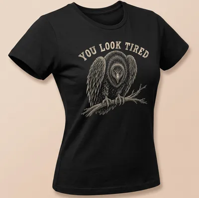 Vintage illustration of a tired vulture with the text 'YOU LOOK TIRED' in brown — printed on a women's shirt